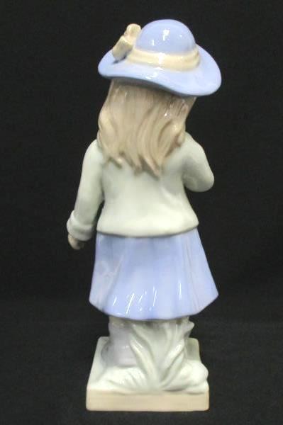 Porcelain Girl Figurine Holding Flower Eyes Closed Sweet Face Lilac Dress Hat