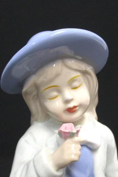 Porcelain Girl Figurine Holding Flower Eyes Closed Sweet Face Lilac Dress Hat
