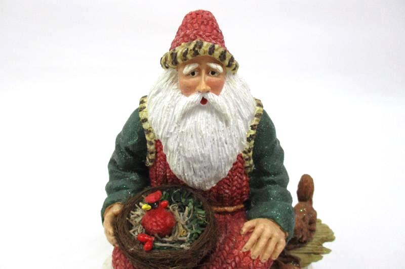 Santa Sitting On A Log Holding A Cardinal Nest Figurine Holiday Collectible
