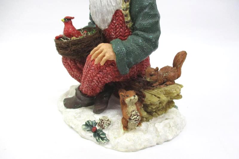 Santa Sitting On A Log Holding A Cardinal Nest Figurine Holiday Collectible