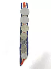 Lot of 7 Coins From Costa Rica On a Red White And Blue Striped Ribbon