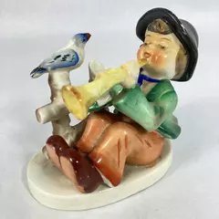 Vintage Japanese Figurine Boy Sitting By A Fence With A Bird Playing a Horn