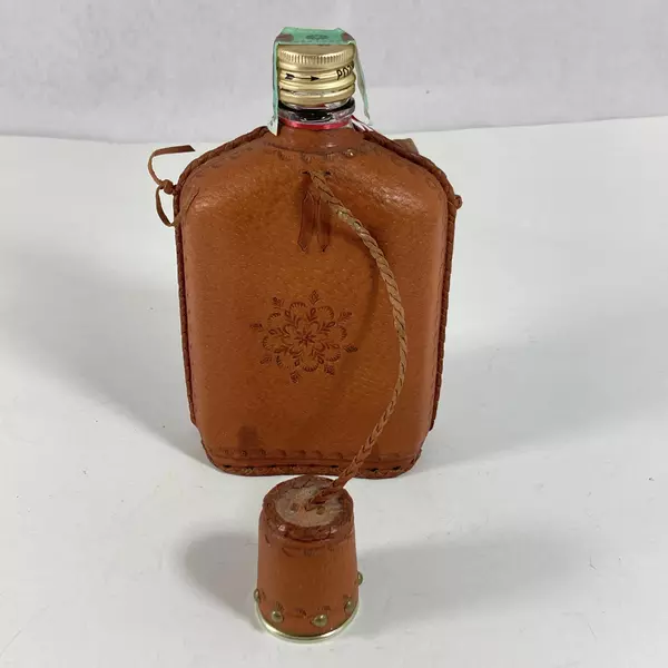 Empty Zubrowka Bison Brand Vodka Flask And Shot Glass Tooled Leather Over Glass