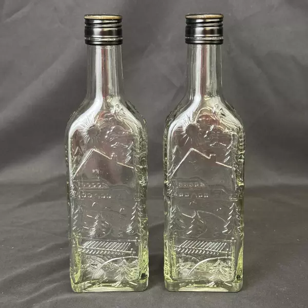 Lot of 2 Brennerei Gruner Baum Embossed Forest Scene Brandy or Liquor Bottles