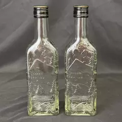 Lot of 2 Brennerei Gruner Baum Embossed Forest Scene Brandy or Liquor Bottles
