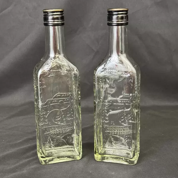 Lot of 2 Brennerei Gruner Baum Embossed Forest Scene Brandy or Liquor Bottles