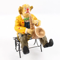 Vintage Clown Figurine Playing the Saxophone Sitting On A Metal Bench