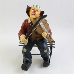 Vintage Clown Figurine Playing The Violin Sitting On A Metal Bench