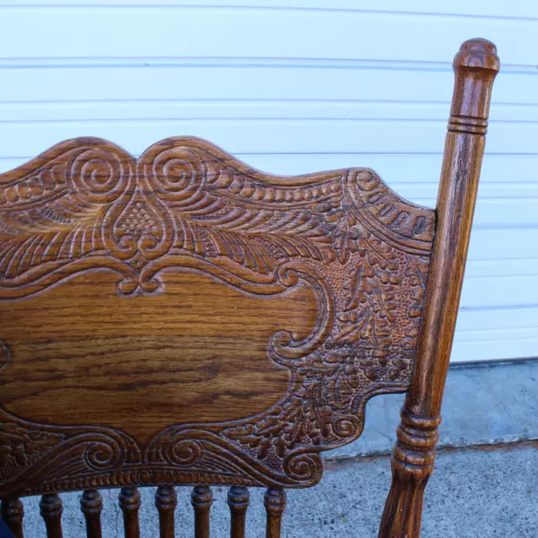 Solid Wood Carved Rocking Chair with Dark Blue Cushioned Support Pads