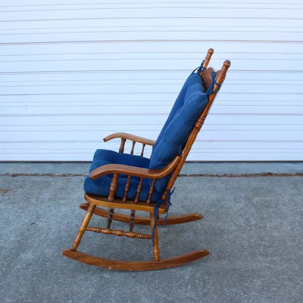 Solid Wood Carved Rocking Chair with Dark Blue Cushioned Support Pads