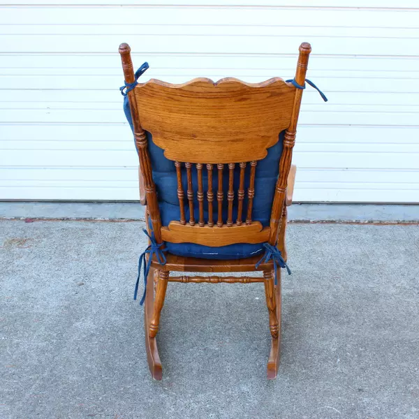 Solid Wood Carved Rocking Chair with Dark Blue Cushioned Support Pads