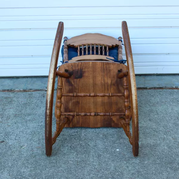 Solid Wood Carved Rocking Chair with Dark Blue Cushioned Support Pads