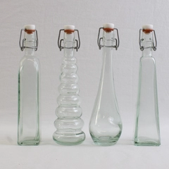 Lot Of 4 Matching 8" Tall Clear Glass Empty Decorative Bottles Assorted Shapes