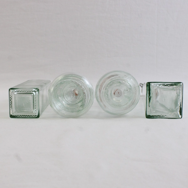 Lot Of 4 Matching 8" Tall Clear Glass Empty Decorative Bottles Assorted Shapes