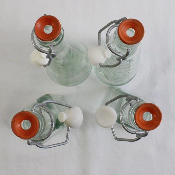 Lot Of 4 Matching 8" Tall Clear Glass Empty Decorative Bottles Assorted Shapes