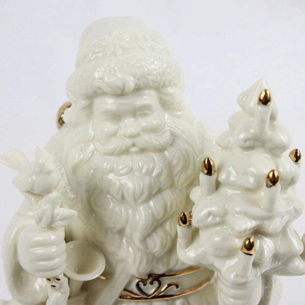 Unbranded Santa Holding Tree and Shovel Figurine Ivory with Gold Trim 10in Tall