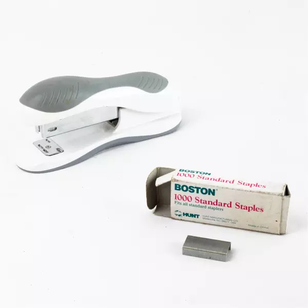 Gray & white 5" Ergonomic Desktop Stapler with Opened Box of Boston Staples