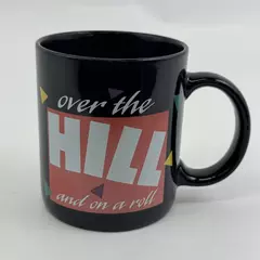 Russ Berrie & Co Inc "Over The Hill And On A Roll" Black Ceramic Mug 3.75" Tall