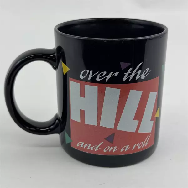 Russ Berrie & Co Inc "Over The Hill And On A Roll" Black Ceramic Mug 3.75" Tall
