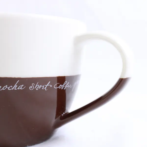 2007 Starbucks Mug with Writing Across Brown and White 13 fl oz.