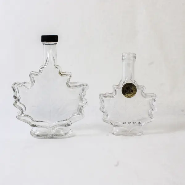 Lot of 2 Vintage Canadian Maple Leaf Glass Syrup Bottles Embossed Leaf