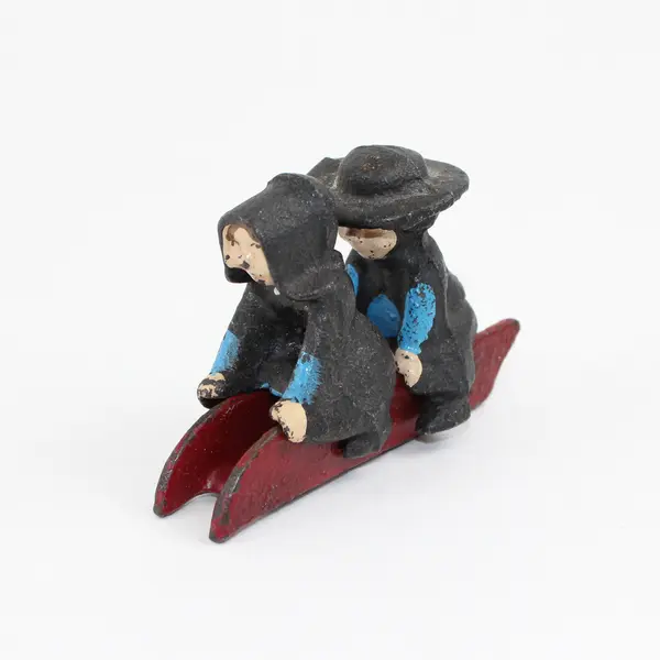 Vintage Cast Iron Amish Girl and Boy on Sled Figure