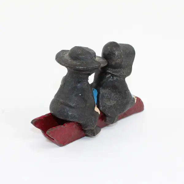 Vintage Cast Iron Amish Girl and Boy on Sled Figure