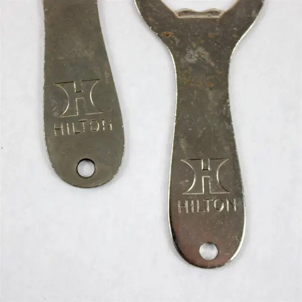 Set of 2 Vintage Hilton Hotels Metal Bottle Openers - Breweriana