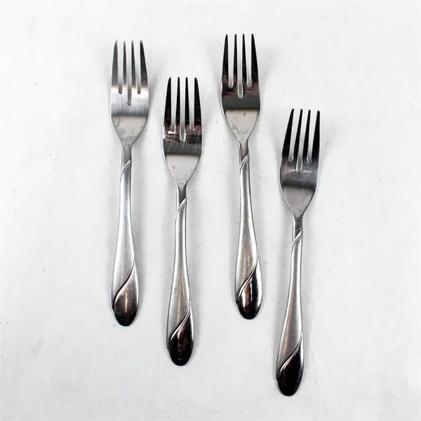 Four Stainless Swirl Sand Salad Forks by Cambridge. Made in China.