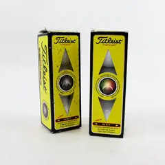 Two Open boxes of 505009 Titleist NXT Tour/Distance Golf balls - 3 per pack. 