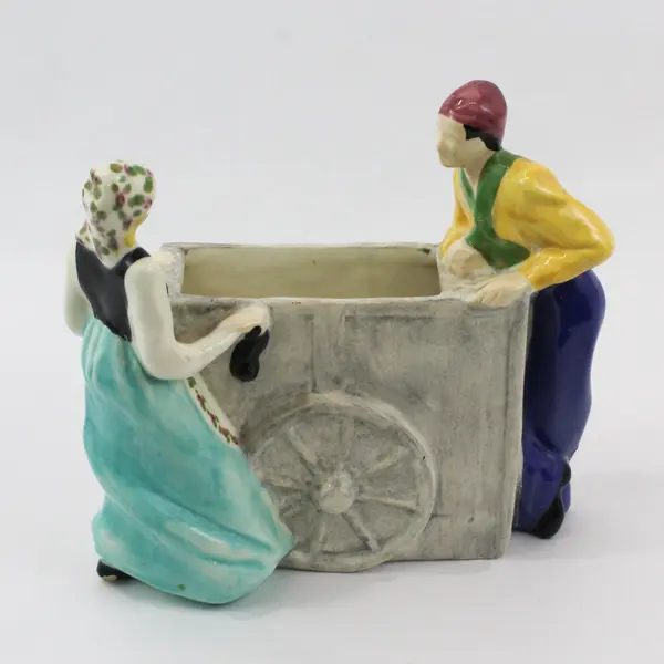 Brayton Laguna Pottery Couple Pushing And Pulling 2 Wheel Cart Planter