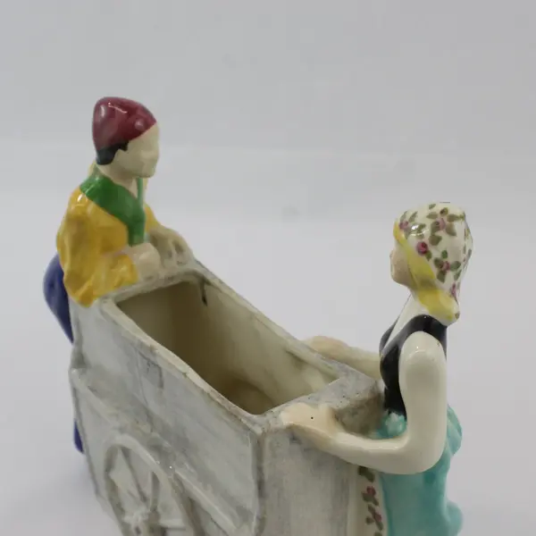 Brayton Laguna Pottery Couple Pushing And Pulling 2 Wheel Cart Planter