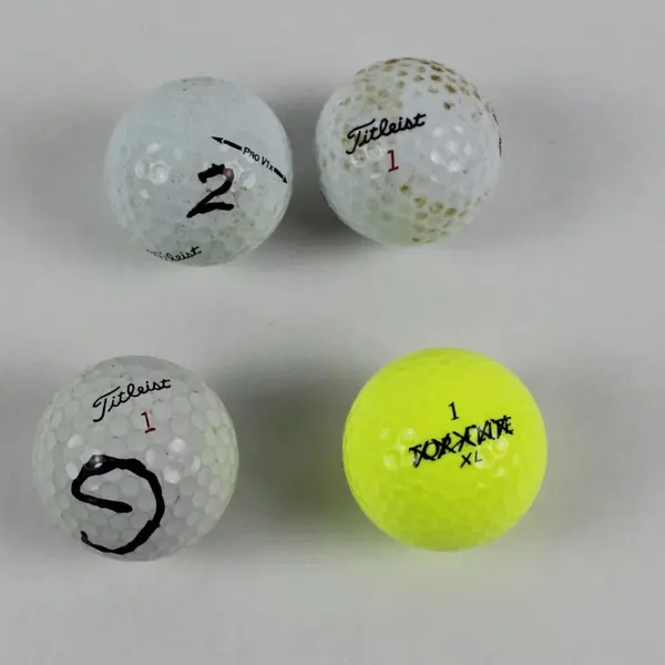 Lot of 4 Mixed Brand Used Golf Balls 3 White 1 Yellow Titleist Top-Flite