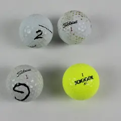 Lot of 4 Mixed Brand Used Golf Balls 3 White 1 Yellow Titleist Top-Flite
