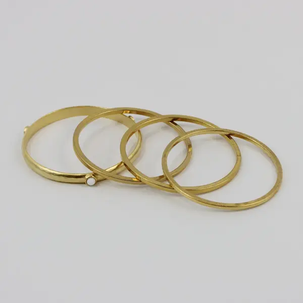Set of 4 Gold Tone Bangle Bracelets One with White Accents